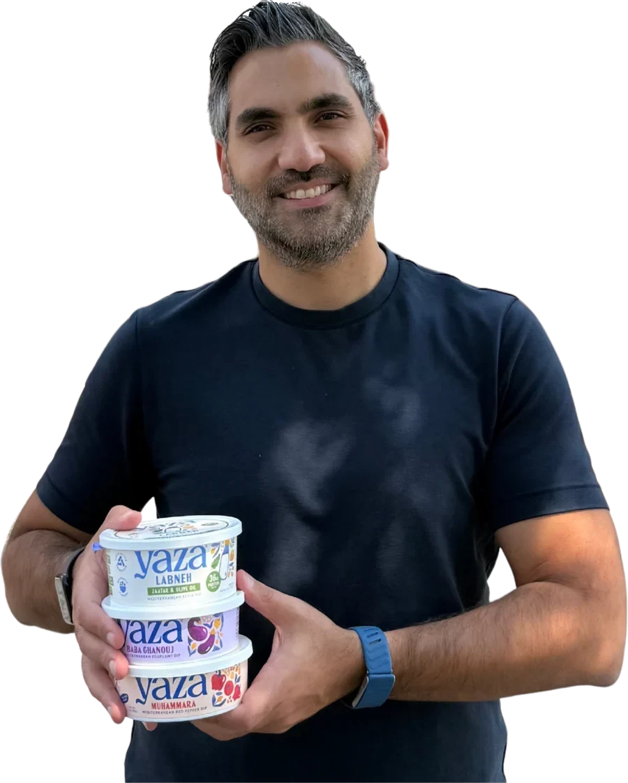 Karim Khalil holding Yaza dips: Za'atar Labneh, Baba Ghanouj and Muhammara